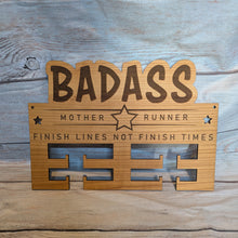 Load image into Gallery viewer, Wooden medal hanger with Badass Mother Runner in text on a wooden background