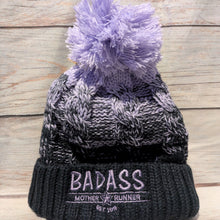 Load image into Gallery viewer, Black and gray beanie with purple pom-pom on a wooden surface