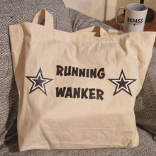 Load image into Gallery viewer, Beige tote bag with 'RUNNING WANKER' text on a textured surface
